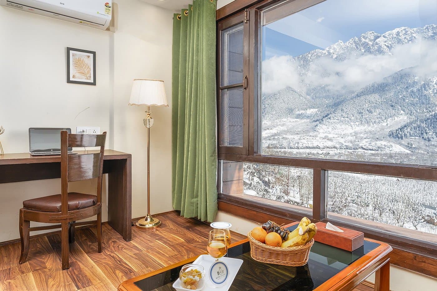 Room at Hotel Sparrow with a panoramic window overlooking snow-capped Himalayan peaks in Pahalgam Room at Hotel Sparrow with a panoramic window overlooking snow-capped Himalayan peaks in Pahalgam