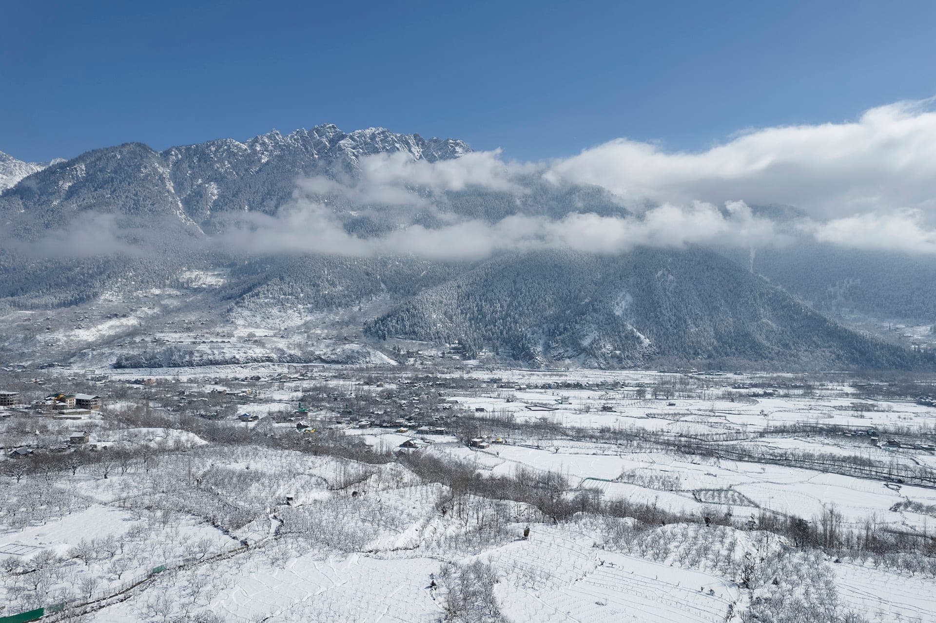 Wide view of the snow-covered Pahalgam valley beneath the Himalayan mountains Wide view of the snow-covered Pahalgam valley beneath the Himalayan mountains