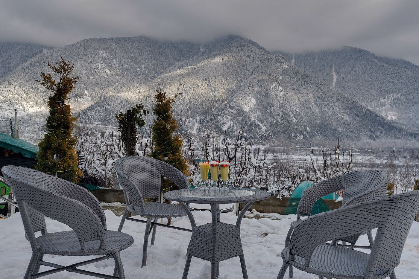 Terrace seating at Hotel Sparrow overlooking snow-dusted Himalayan mountains Terrace seating at Hotel Sparrow overlooking snow-dusted Himalayan mountains